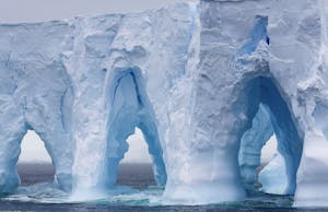 Huge arched iceberg south of the Antarctica Circle, Antarctica © Ron Niebrugge