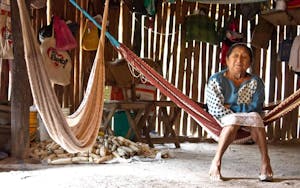 A WOMAN RELAXES IN A HAMMOCK