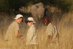 Travelers walking with Rhinos © Imvelo Safari Lodges